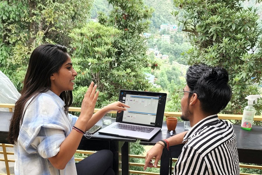 Two people working together on a laptop